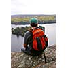 Man on top of a hill enjoying a scenic view