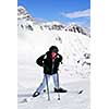 Young girl downhill skiing on the backdrop of scenic view in Canadian Rocky mountains ski resort