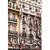 Fragment of a Paris building with autumn trees