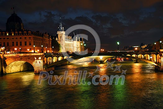 Bridges over Seine and Conciege in nighttime Paris France