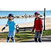 Two girls rollerblading on lake shore trail