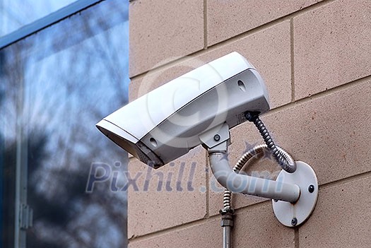 Security video camera on outside wall of a building