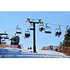 Chairlift with skiers on downhill ski resort