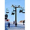Chairlift with skiers on downhill ski resort