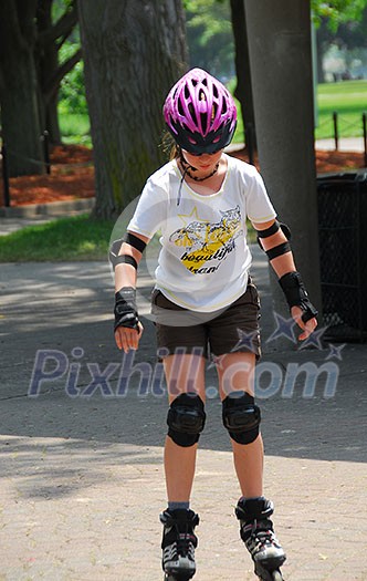 Young girl rollerblading in a summer park Young girl rollerblading in a summer park