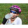 Young girl taking a break from rollerblading drinking water