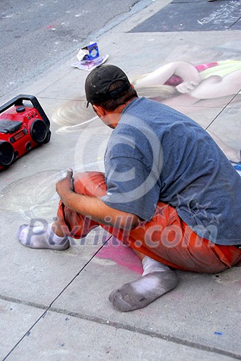Street artist drawing with chalk on sidewalk Street artist drawing with chalk on sidewalk