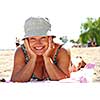 Mature woman lying on a sandy beach