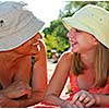 Grandmother and granddaughter relaxing on a sandy beach