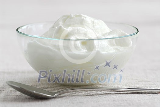 Fresh yogurt served in a clear glass bowl