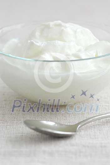 Fresh yogurt served in a clear glass bowl