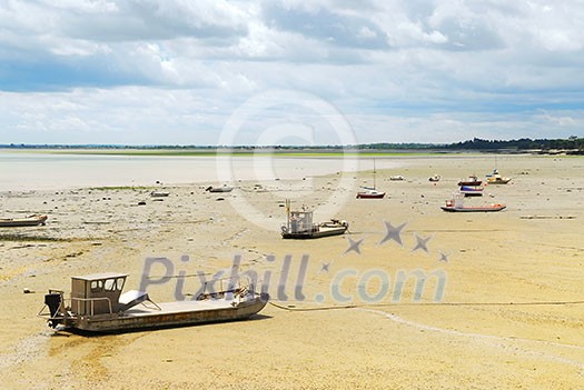 Fishing boats on the ocean floor at low tide in Cancale (Brittany, France) Fishing boats on the ocean floor at low tide in Cancale (Brittany, France)