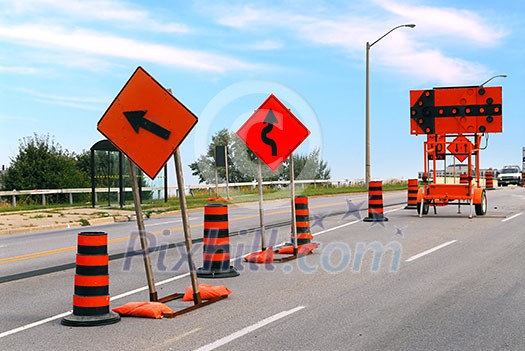 Road construction signs and cones on a city street