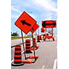 Road construction signs and cones on a city street