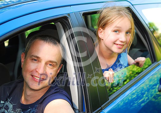 Father and daughter sitting inside the car ready to go on family trip