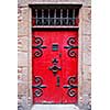 Red medieval door in Mont Saint Michel abbey in France