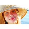 Portrait of a teenage girl wearing straw hat on a beach