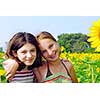 Portrait of two young girls in a sunflower field