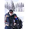 Father and daughter enjoying downhill skiing in winter mountains