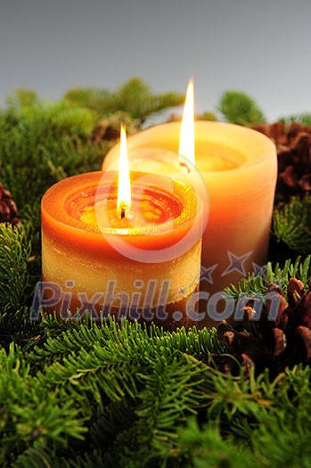 Christmas arrangement of burning candles and green spruce branches