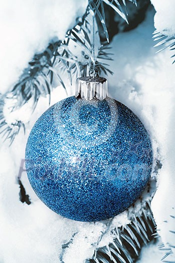 Christmas decoration hanging on snow covered spruce tree outside Christmas decoration hanging on snow covered spruce tree outside