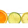 Orange lemon and lime slices in water with air bubbles on white background