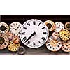 Several antique clock faces of different sizes and styles