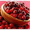 Fresh red cranberries in a wooden bowl 