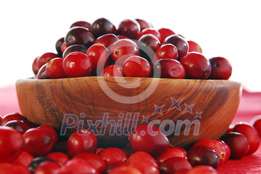 Fresh red cranberries in a wooden bowl Fresh red cranberries in a wooden bowl