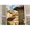 View from an open window with shutters in town of Cognac, France