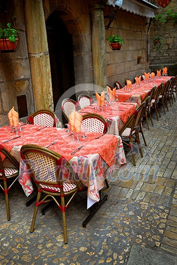 Outdoor restaurant patio on the street of Sarlat, Dordogne region, France