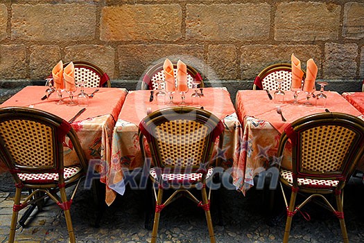 Outdoor restaurant patio on medieval street of Sarlat, Dordogne region, France