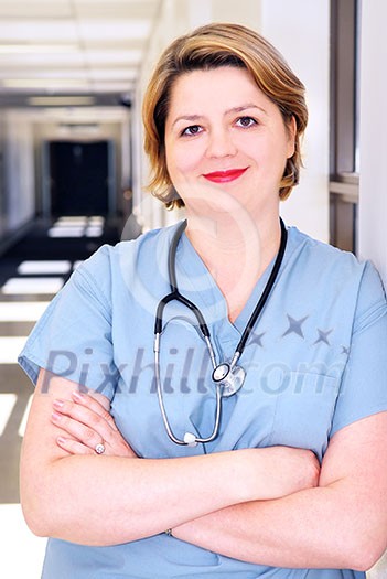 Portrait of a smiling nurse in standing in a hospital corridor