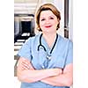 Portrait of a smiling nurse in standing in a hospital corridor