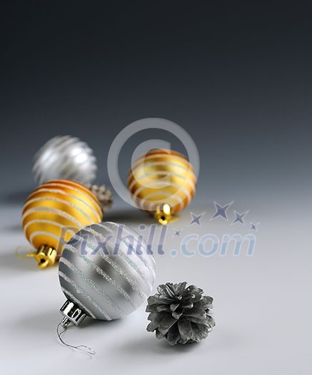 Christmas background with glass bauble ornaments and pine cones