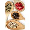 Four kinds of peppercorns in wooden cooking spoons