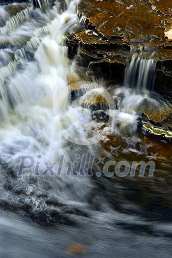 Waterfall cascading over natural rocks close up Waterfall cascading over natural rocks close up