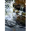 Waterfall cascading over natural rocks close up