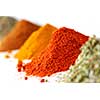 Heaps of various ground spices on white background