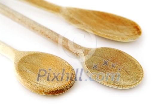 Old wooden cooking spoons isolated on white background