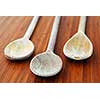 Old wooden cooking spoons on a cutting board in a kitchen