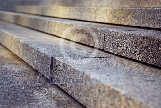 Close up on granite stairs in perspective with sunlight Close up on granite stairs in perspective with sunlight