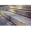 Close up on granite stairs in perspective with sunlight