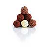 Pyramid of assorted chocolate truffles on white background with reflection