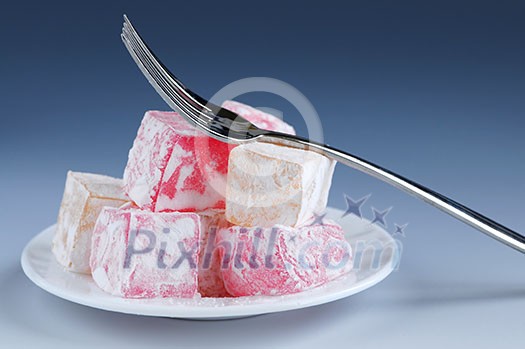 Turkish delight (lokum) confection on a white dessert plate Turkish delight (lokum) confection on a white dessert plate