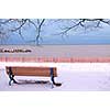 Winter park with a bench covered with snow. Beach area, Toronto, Canada.