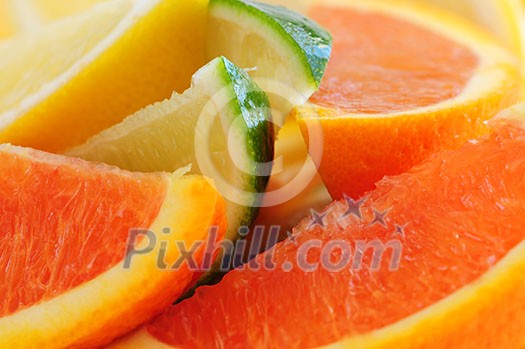 Wedges of assorted citrus fruits lemon orange and lime