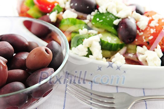 Black kalamata olives and greek salad with feta cheese