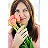 Smiling mature woman holding bouquet of flowers
