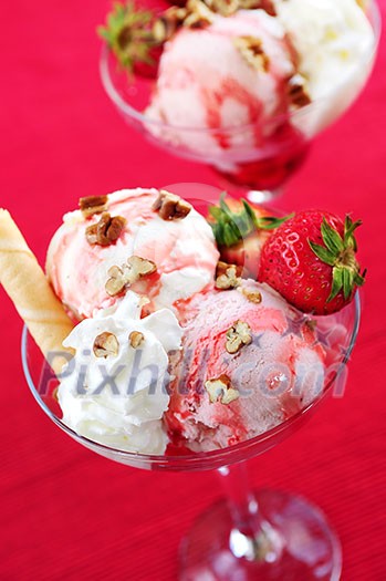 Strawberry ice cream sundae with fresh strawberries and walnuts